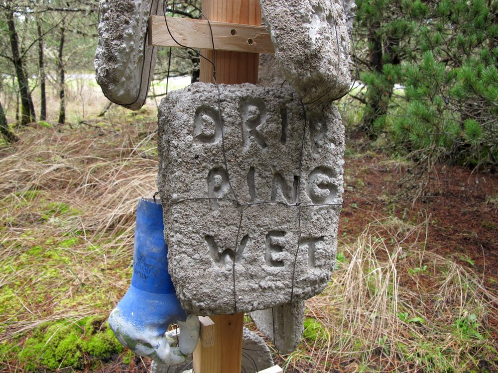 Concrete slab with text hanging from post