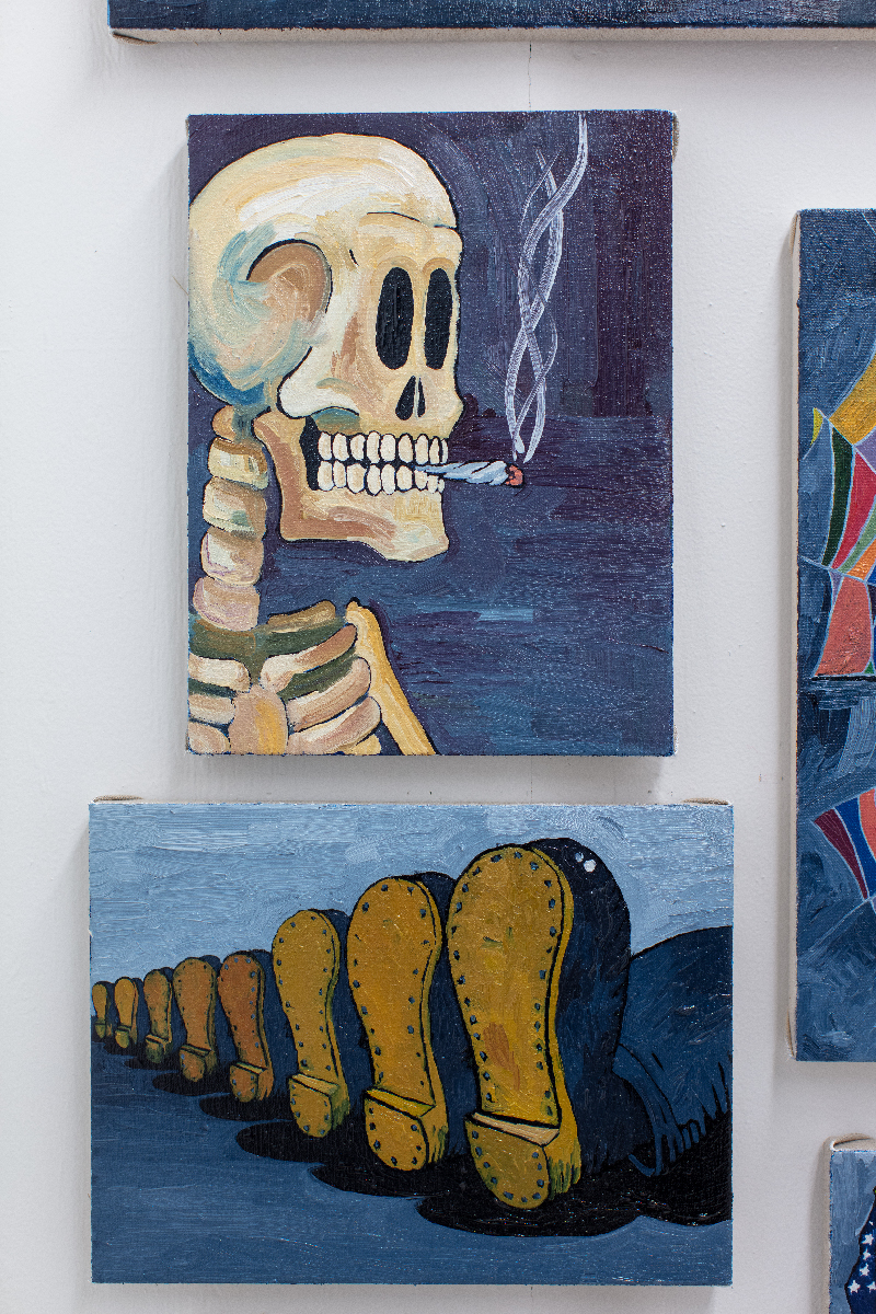Two paintings, one of a skeleton smoking a cigarette, the other of a row of boots mid stride.