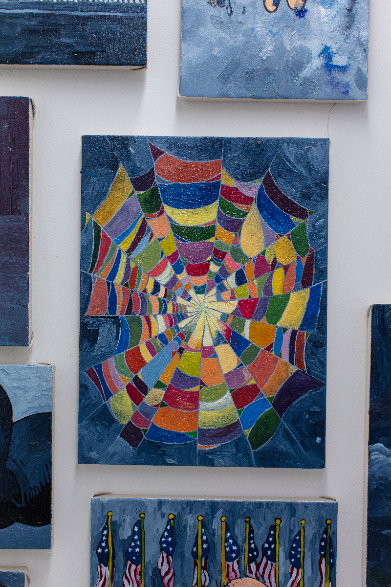 A painting of a spider web that resembles a quilt