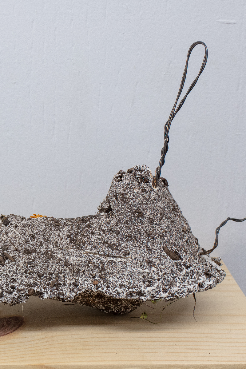 Detail of a plaster sculpture with protruding wire.