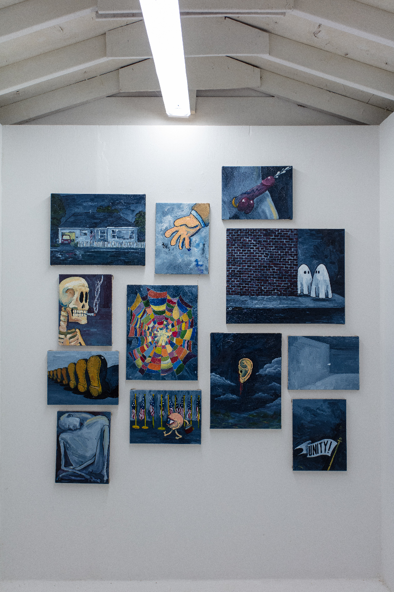 A group of paintings on a small wall