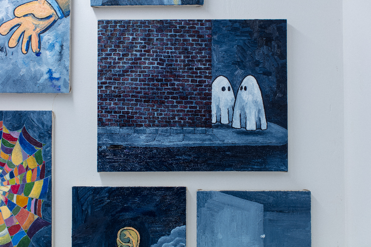 A painting of cartoony ghosts standing on a street corner beside a brick wall